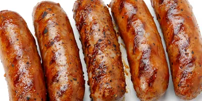 Barbacued sausages on a white background