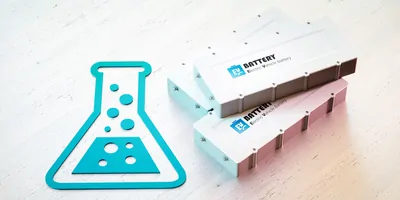 Li-Ion electric vehicle battery research concept. Scientific symbol with EV batteries on wooden desk. 3d rendering.