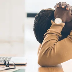 lack businessman feeling upset and desperate, working at office, hands on head. Free space