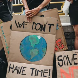Protestors against climate change and environmental damage. holding cardboard signs