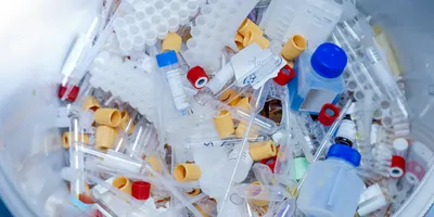 A large pile of various disposable lab consumables and plasticware