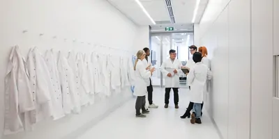 Scientists stand in a circle and talk