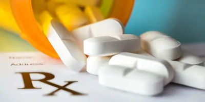 White pills on a perscription pad