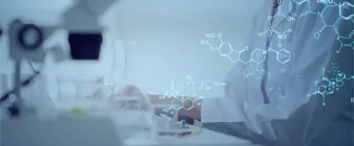 Stock photo illustration of a scientist typing on a computer at the lab bench with chemical equations overlaid on the image. (hero format)