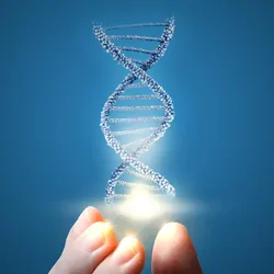 human hand holding a model of DNA on a blue background