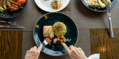 Women eating salmon at a restaurant