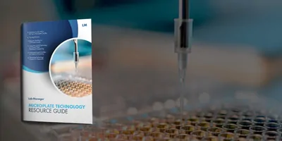 a photo of the cover of the microplate technology resource guide overlayed on top of a photo of an automated liquid handler dropping liquid into a microplate