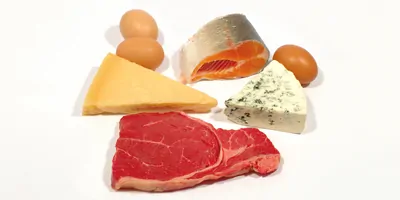 A variety of high protein foods on a white background