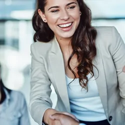 Professional woman shaking hands with male colleague