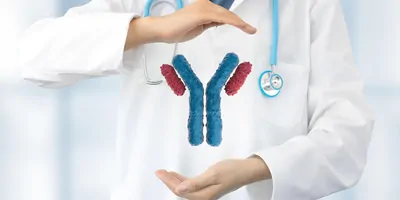 doctor holding a CGi representation of antibodies