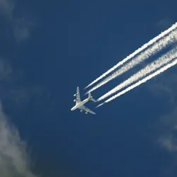 Jet flying through the sky with jet streams tracing it