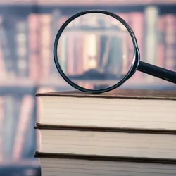 Books and magnifying glass