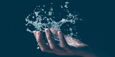 A human hand holding a graphic splash of water