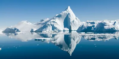 Icebergs drift in calm seas off the Greenland coast