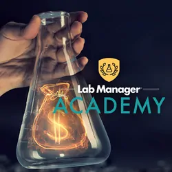 Scientist holds a beaker with a glowing money bag inside. Lab Manager Academy logo overlays the image.