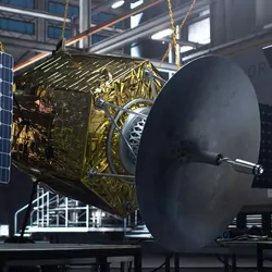 Engineer working on a satellite 