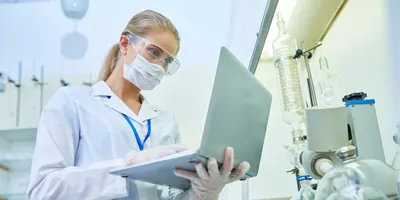 female scientist working on laptop in the lab