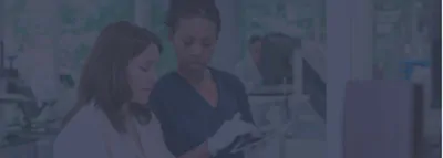 two scientists in hospital lab looking for accreditation