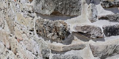 A roman built wall made of stone and concrete