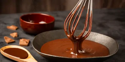 Melted chocolate in a bowl being whisked