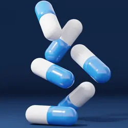 Close up of pills being poured onto a table