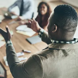 A leader running a meeting with coworkers 