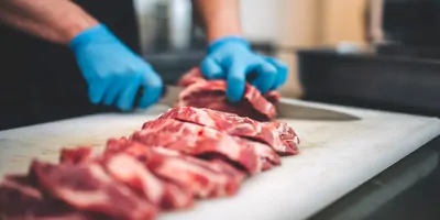 A butcher cutting slabs of meat