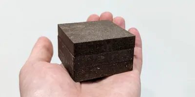 Starcrete in a persons hand, on a white background