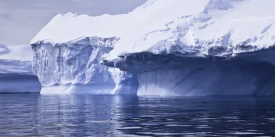 A sheet of ice hanging off an iceberg