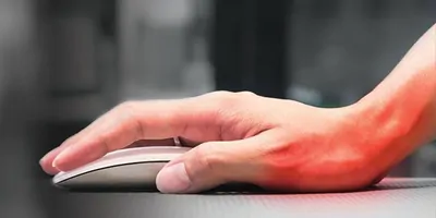 A hand using a mouse. The hand has red on it to show the concept of an ergonomic injury.
