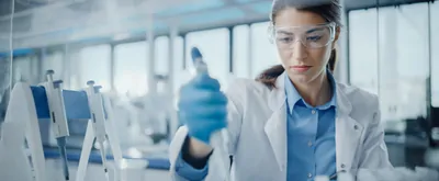 female scientist using a pipette in the lab