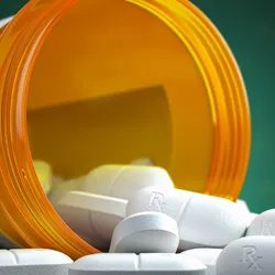 Pills spilling out of a medicine container