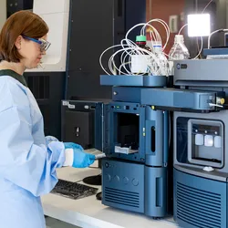 Female scientist working with a mass spec instrument in the lab