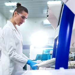 A medical research laboratory with a diverse team of biochemical scientists working with computers and modern medical technologies. 
