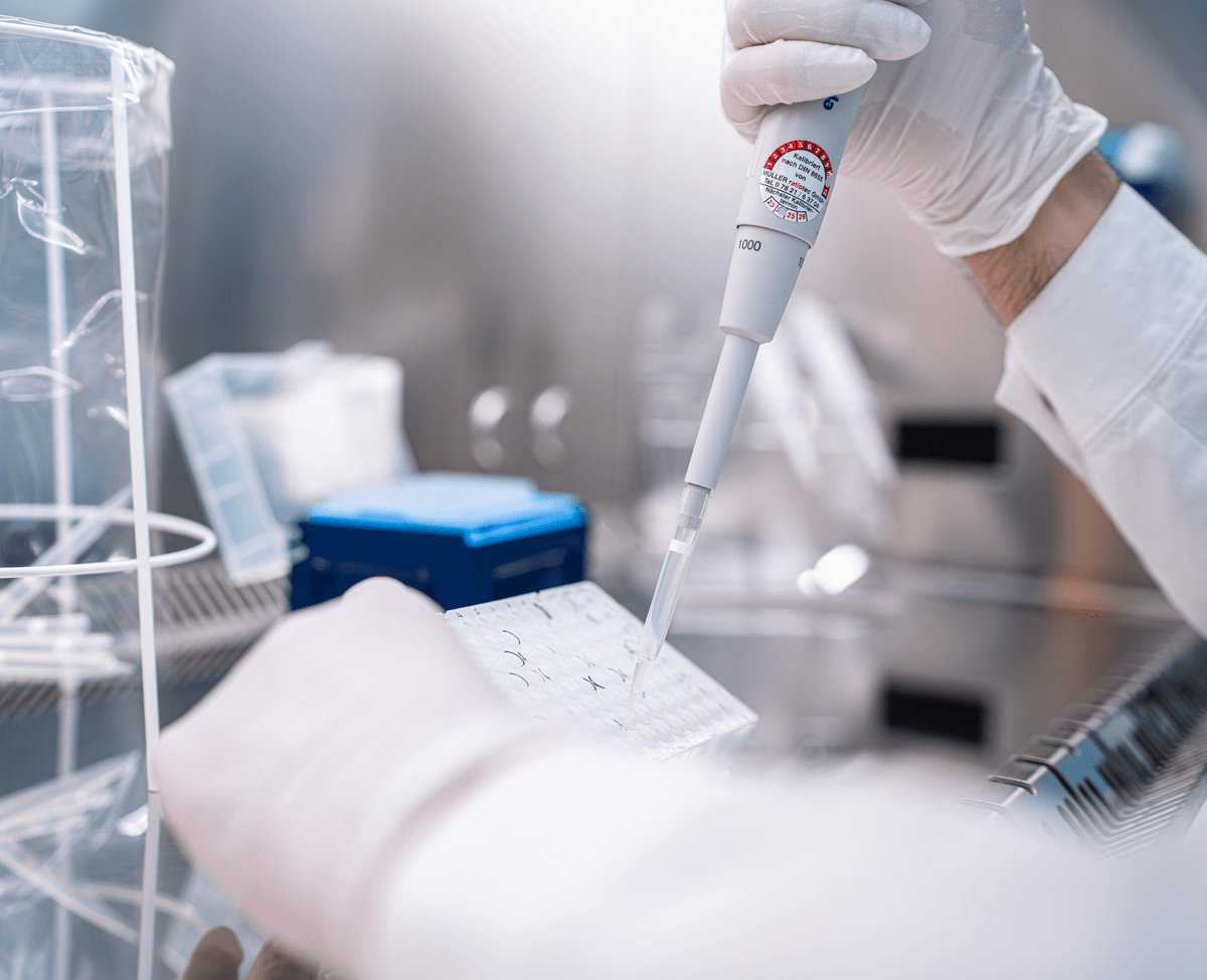 Hands pipetting in lab