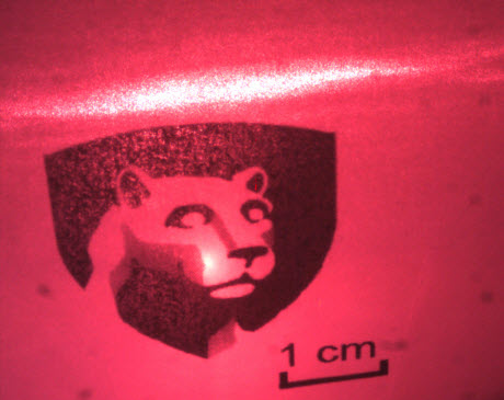 red laser beam shining on Penn State logo