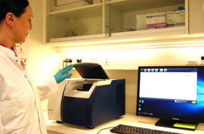 The sample cup is placed in the spectrometer for visible near-infrared spectroscopy measurement