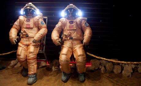 Crew members try out their spacesuits