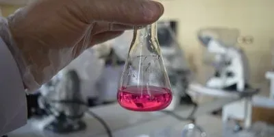 hand holding erlenmeyer flask