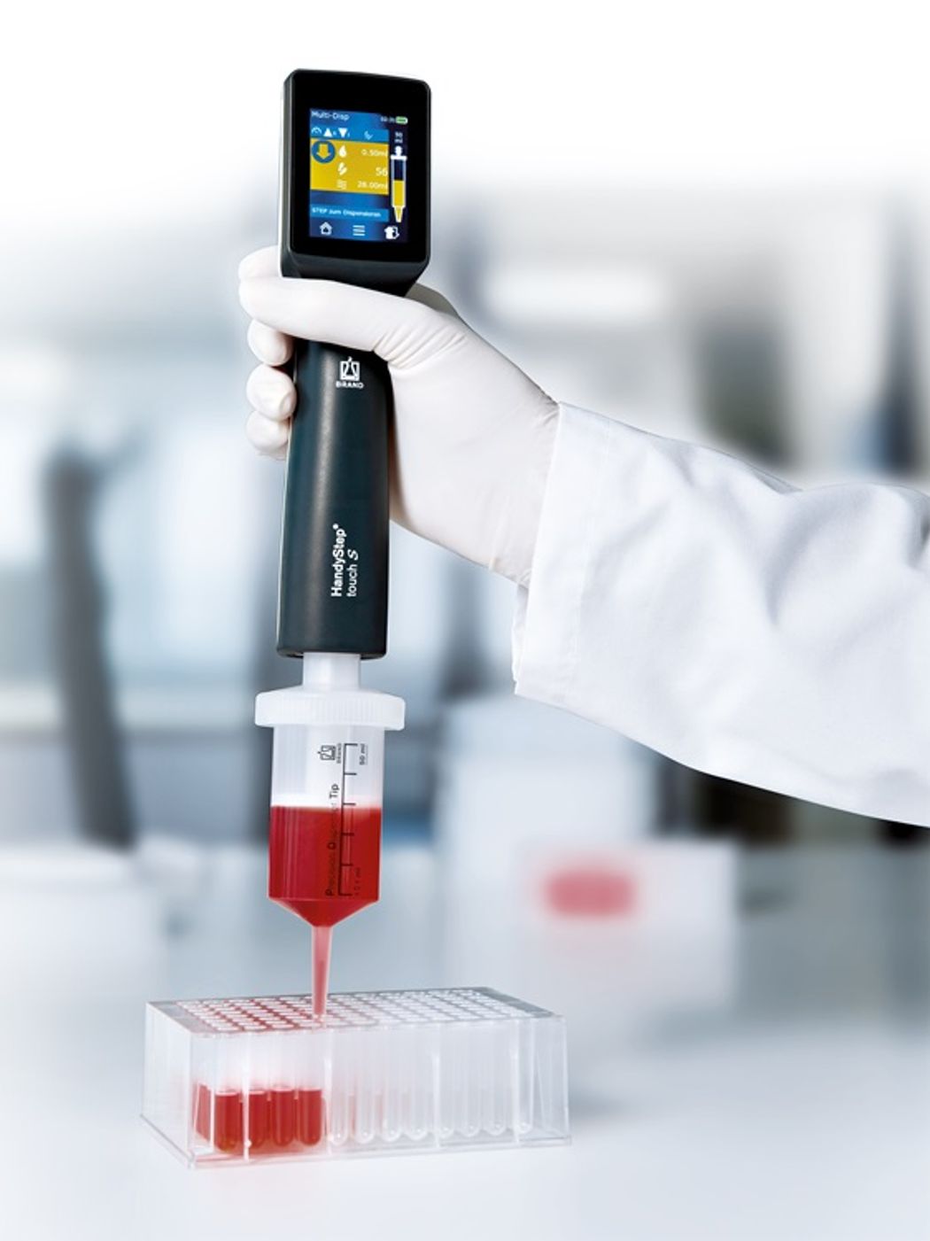 Scientist wearing latex gloves uses the BrandTech HandyStep Touch S