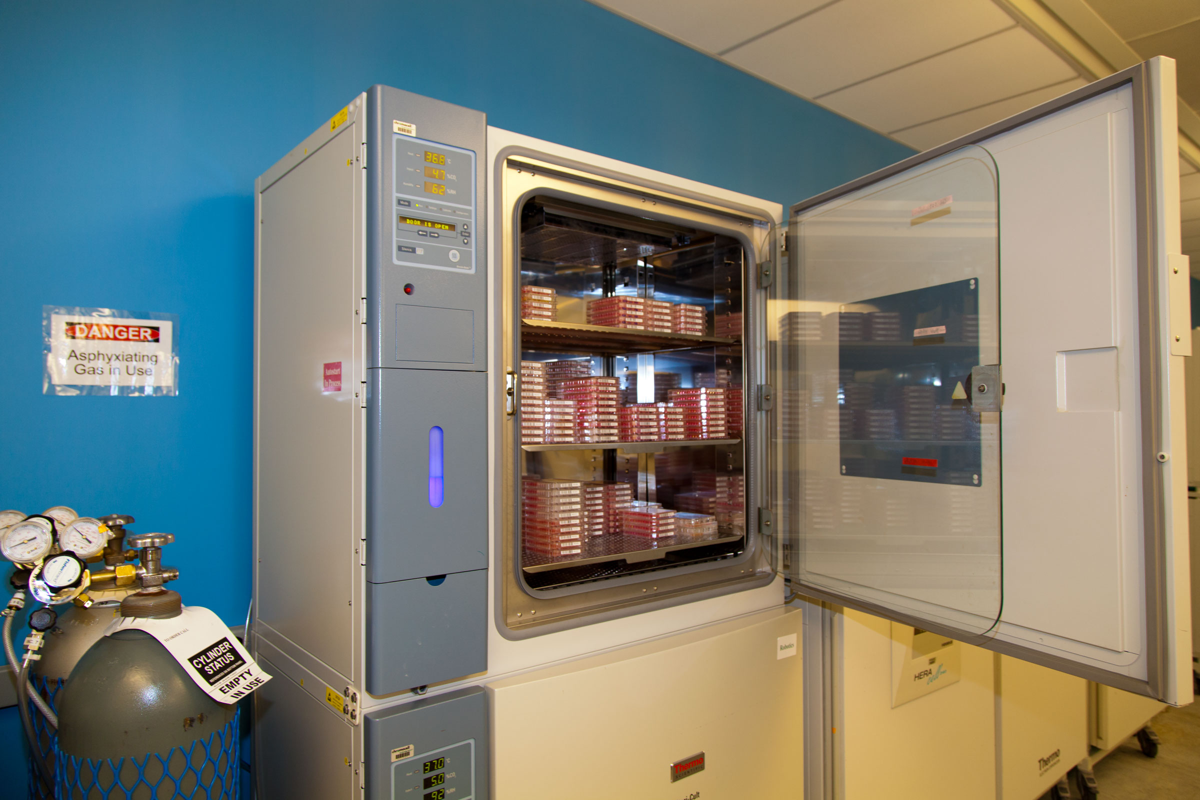 An open incubator, filled with media