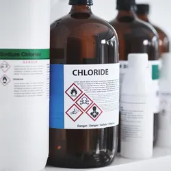 Image of laboratory chemicals on a shelf displaying proper chemical labeling