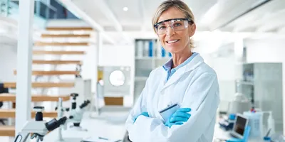 image of a female lab manager standing with arms crossed wearing safety equipment and suggesting the importance of manager safety responsibilities