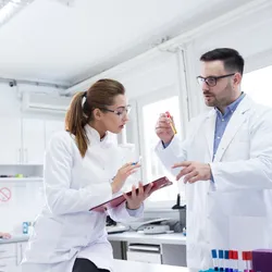 Lab manager trains a younger scientist