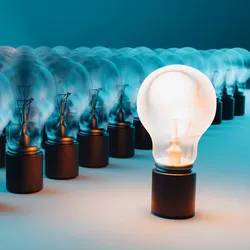 image of a lit lightbulb standing in front a a field of unlit bulbs suggesting the importance of entrepeneurship and intrapeneurship in science and discovery