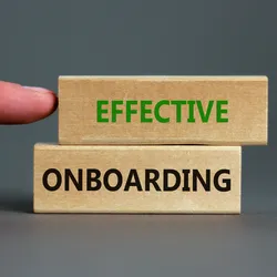 wooden blocks with the words effective onboarding printed on them emphasizing the importance of developing an onboarding strategy