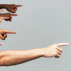 image of multiple hands pointing toward the right of the image illustrating the concept of assigning blame