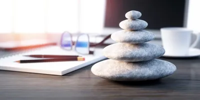 image of stached stones on a desktop suggesting the idea of a calm and productive workplace
