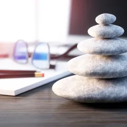 image of stached stones on a desktop suggesting the idea of a calm and productive workplace
