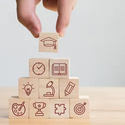 image of stached blocks with icons representing types of knowledge emphasizing the importance of knowlege management and sharing